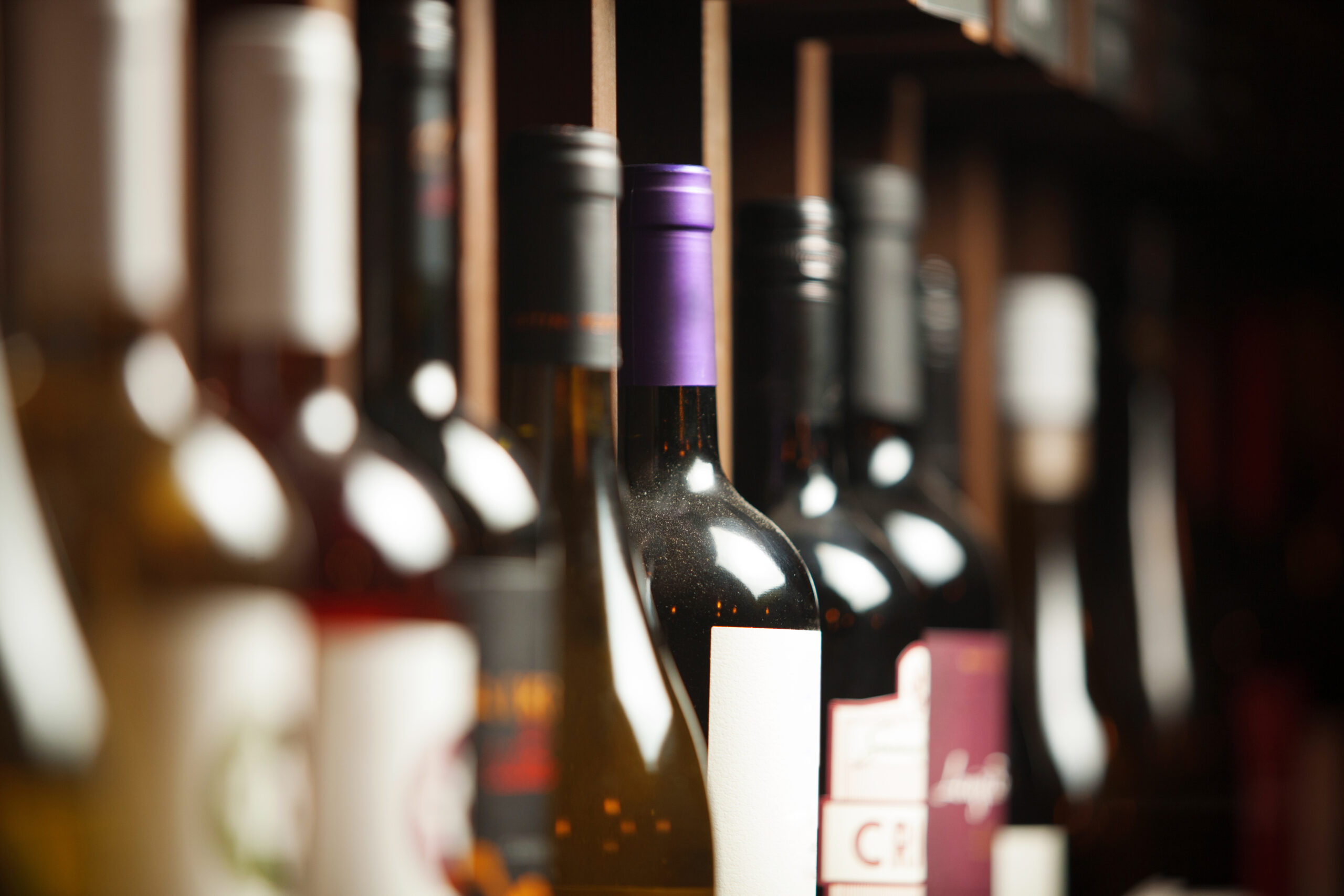 Wine cellar with elite drinks on shelves with written names
